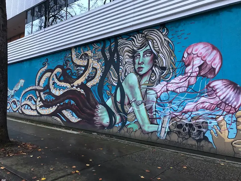 Art mural on the side of a building of a mermaid