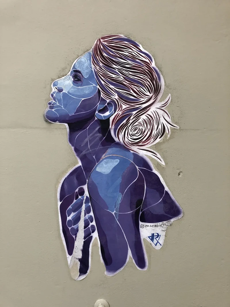 A sticker of a woman's side profile with purple tones.