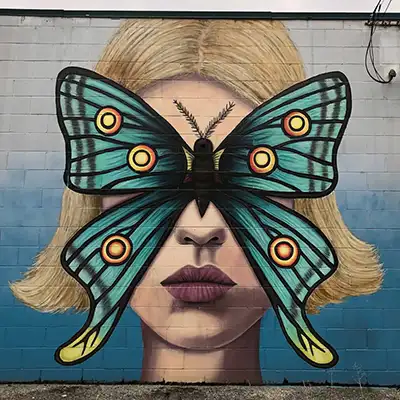 Art Mural of a girl with a butterfly on her face covering