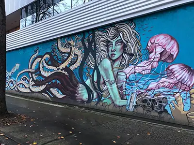 Art mural on the side of a building of a mermaid